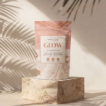 Product packaging labeled 'GLOW' on a stone block with palm leaf shadows on the wall.