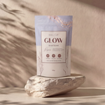 Product packaging labeled 'GLOW' on a stone surface with a neutral background