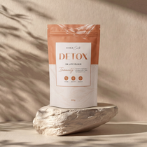 Package of 'Detox' on a stone surface with a neutral background
