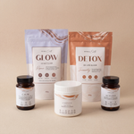Collection of health and wellness products including bottles and containers on a beige background